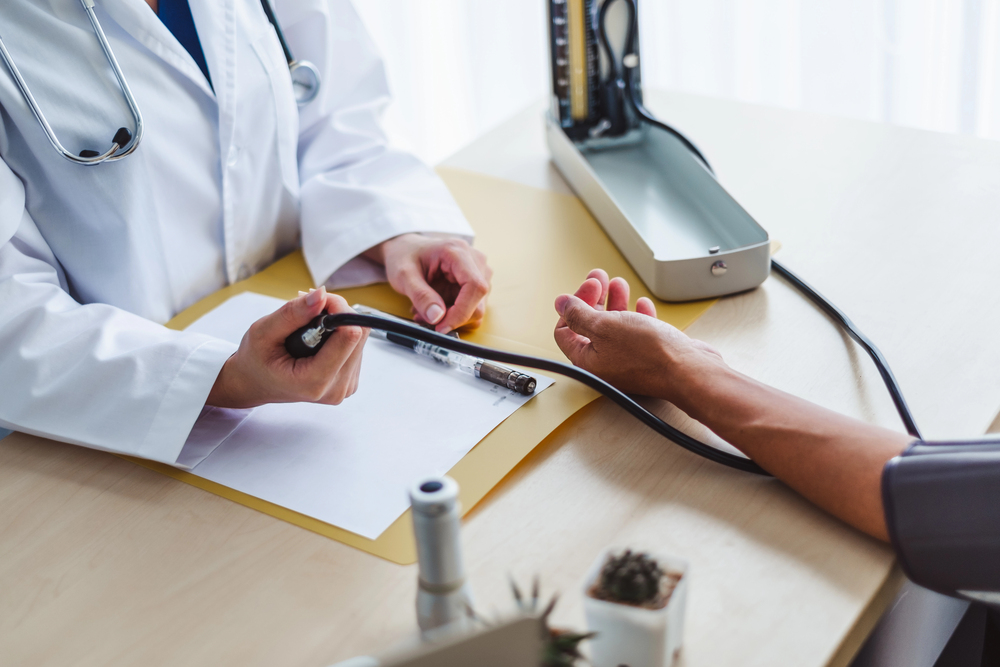 Doctor measuring a patient’s blood pressure.